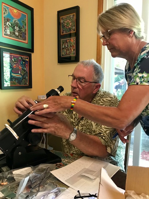 Lion Kay, Optician, teaches in-coming President, Dick, how to calibrate used eyeglasses for the next vision clinic to developing countries.